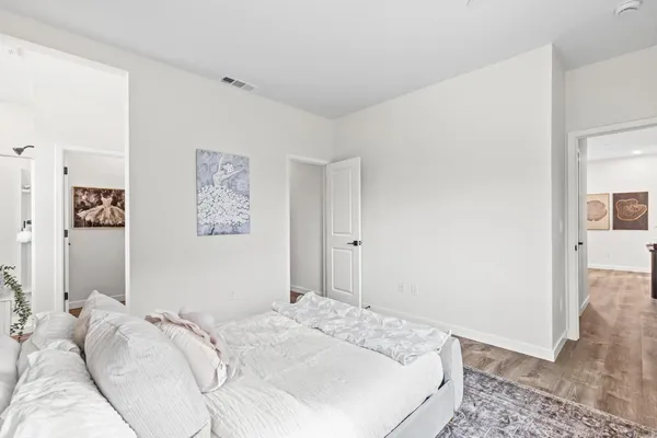 a bedroom with a bed and a view of bathroom