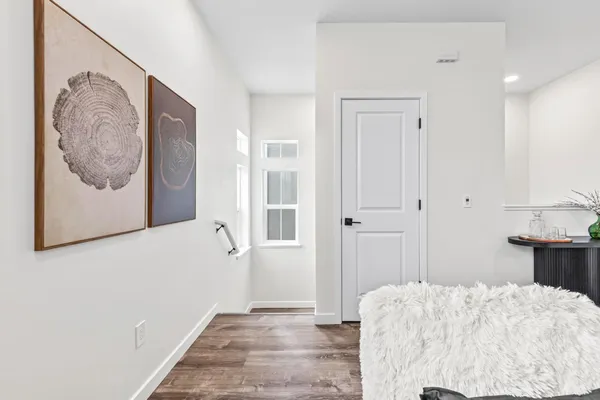a bedroom with a bed and a painting on the wall