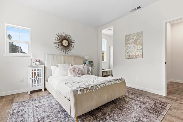 a bedroom with a bed and a painting on the wall