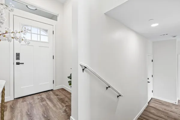 a view of a bedroom with wooden floor and staircase