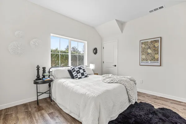 a bedroom with a bed and a window