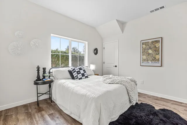 a bedroom with a bed and a window