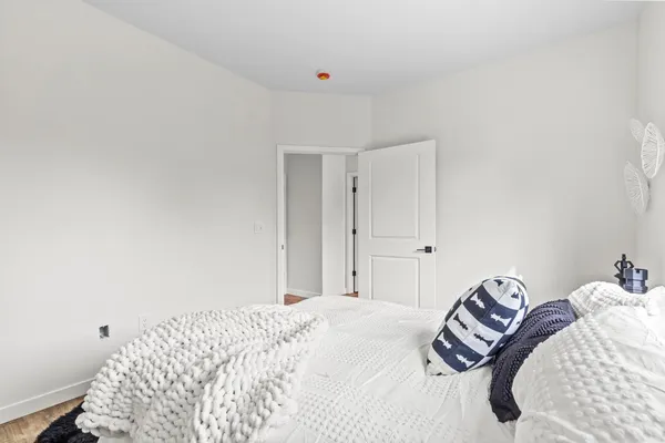 a bedroom with a bed and a painting on the wall