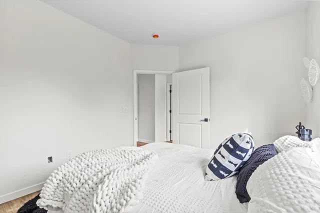 a bedroom with a bed and a painting on the wall