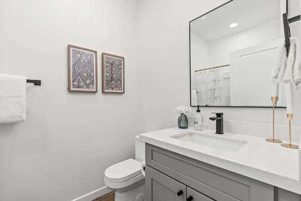 a bathroom with a toilet sink and mirror