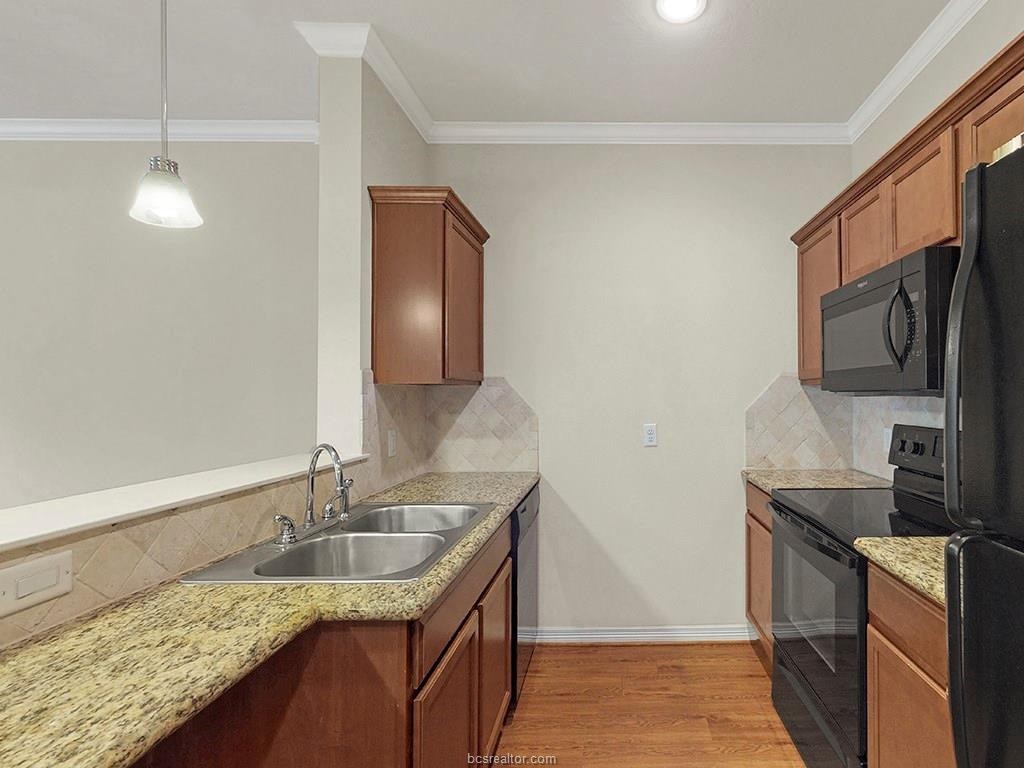 1198 Jones-Butler Road, Unit 2607 College Station, TX 77840 - Photo 8 of 26 a kitchen with stainless steel appliances granite countertop a sink stove and refrigerator