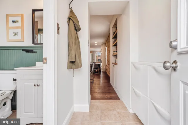 a view of a hallway with entryway wooden floor and front door