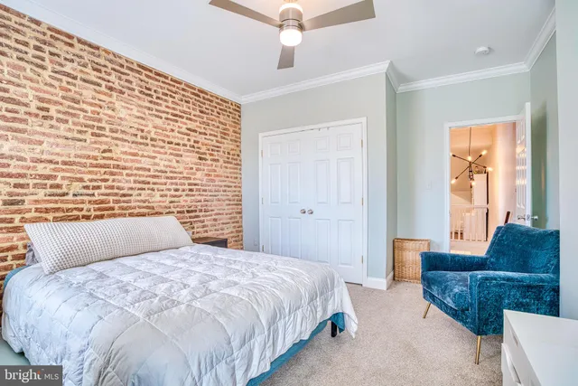 a bedroom with a bed couch and a window