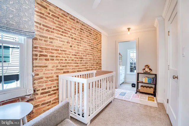 a view of a hallway with windows and stairs