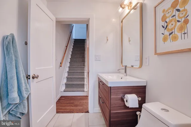 a bathroom with a toilet sink and mirror