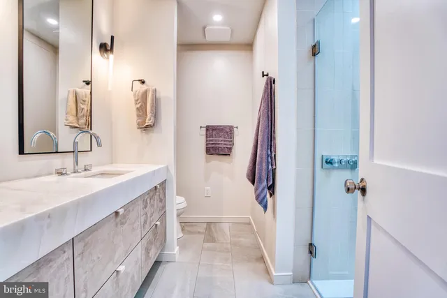 a bathroom with a tub sink and mirror