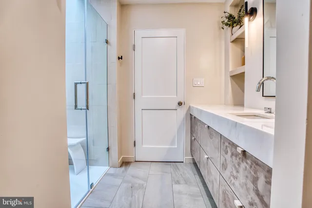 a bathroom with a double vanity sink and a mirror