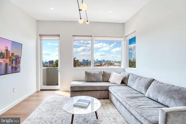 a living room with furniture and a large window
