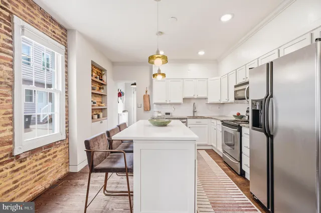 a kitchen with a sink appliances and cabinets