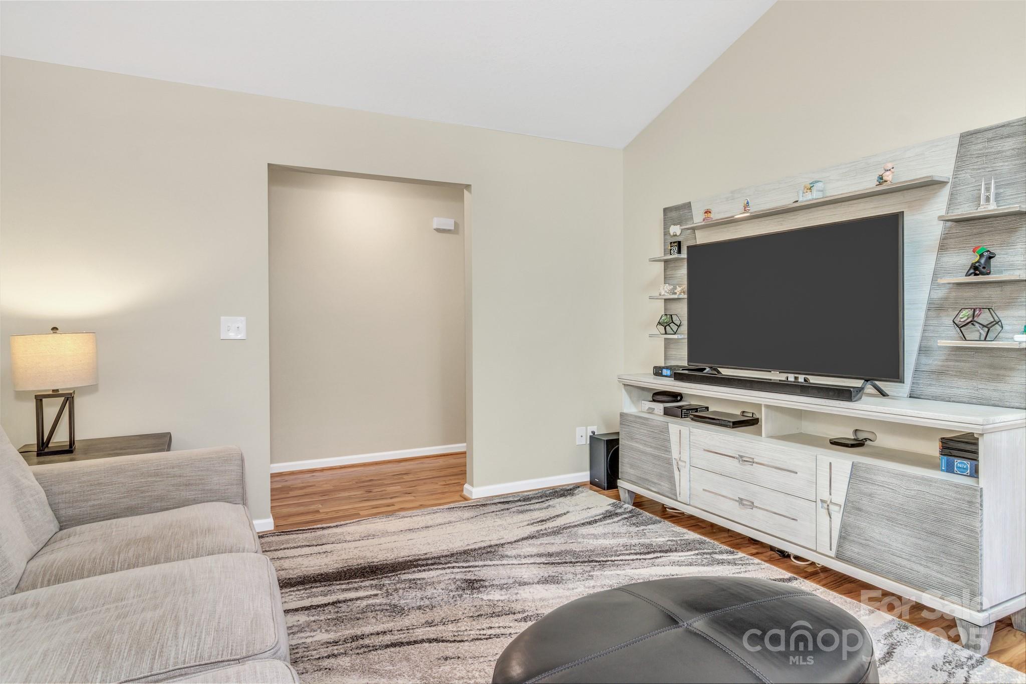 210 Allen Paul Road Hendersonville, NC 28791 - Photo 13 of 48 a bedroom with a bed and a flat screen tv