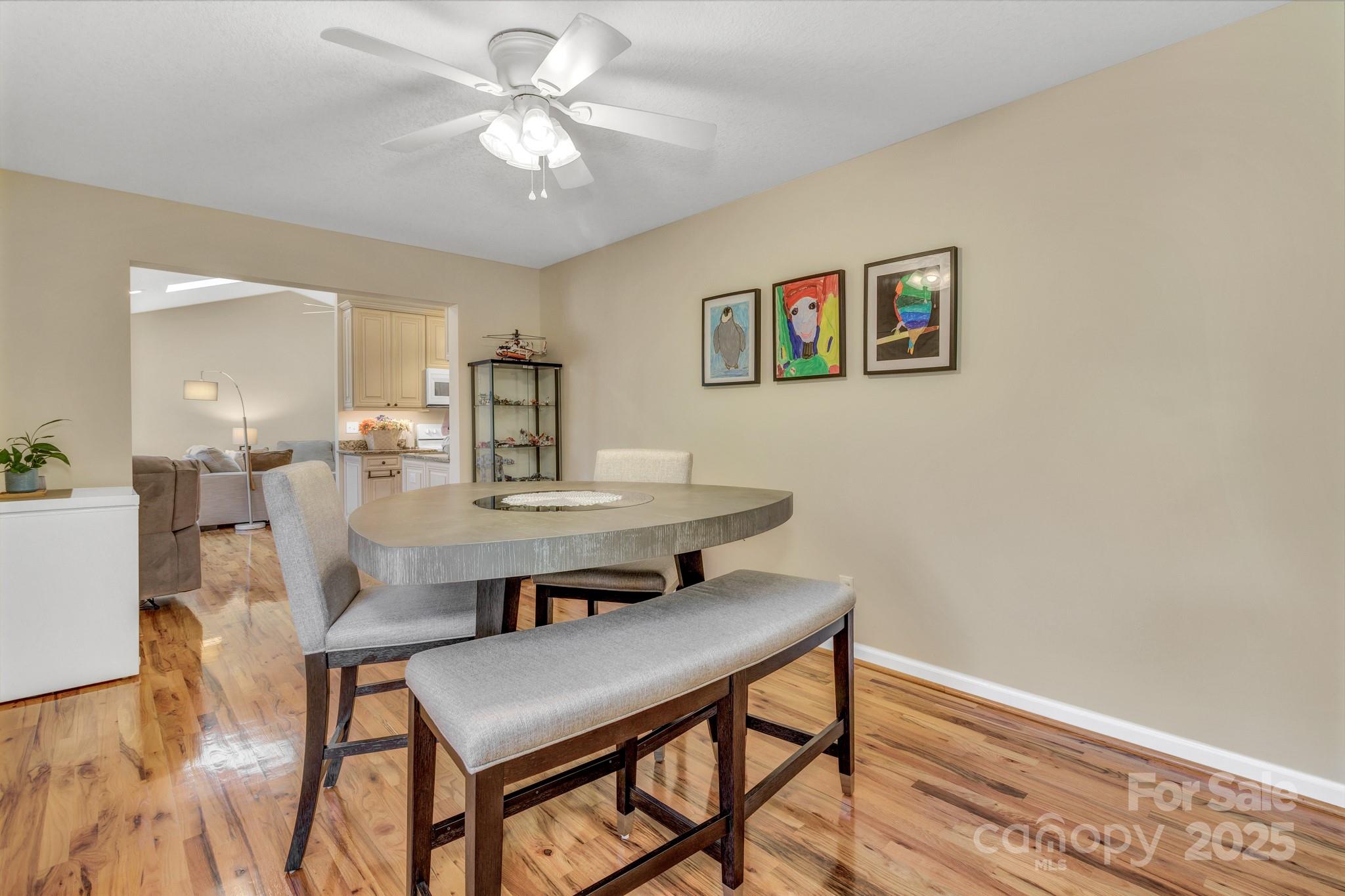 210 Allen Paul Road Hendersonville, NC 28791 - Photo 16 of 48 a view of a dining room with furniture and wooden floor