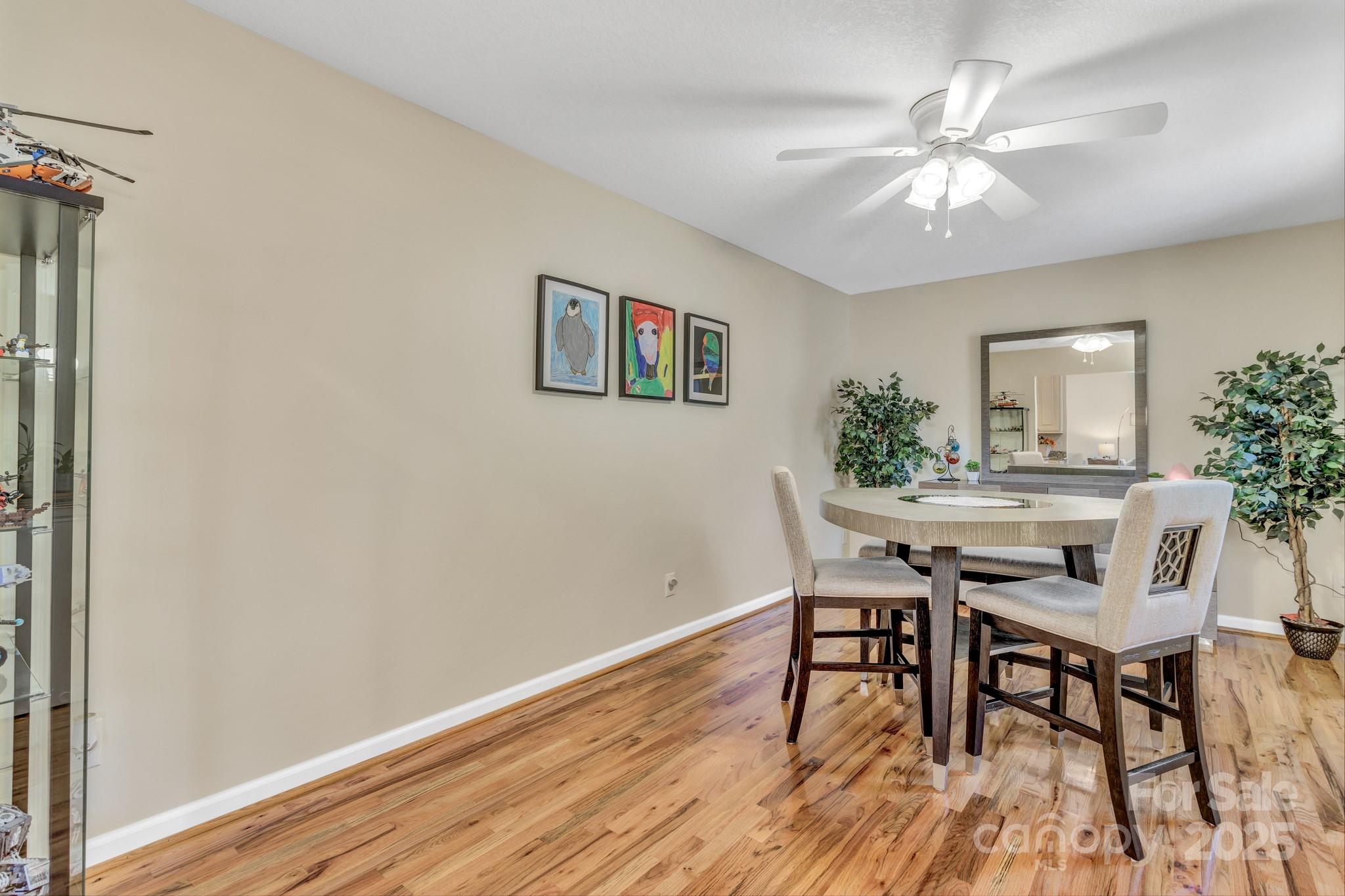210 Allen Paul Road Hendersonville, NC 28791 - Photo 18 of 48 a view of a dining room with furniture and wooden floor
