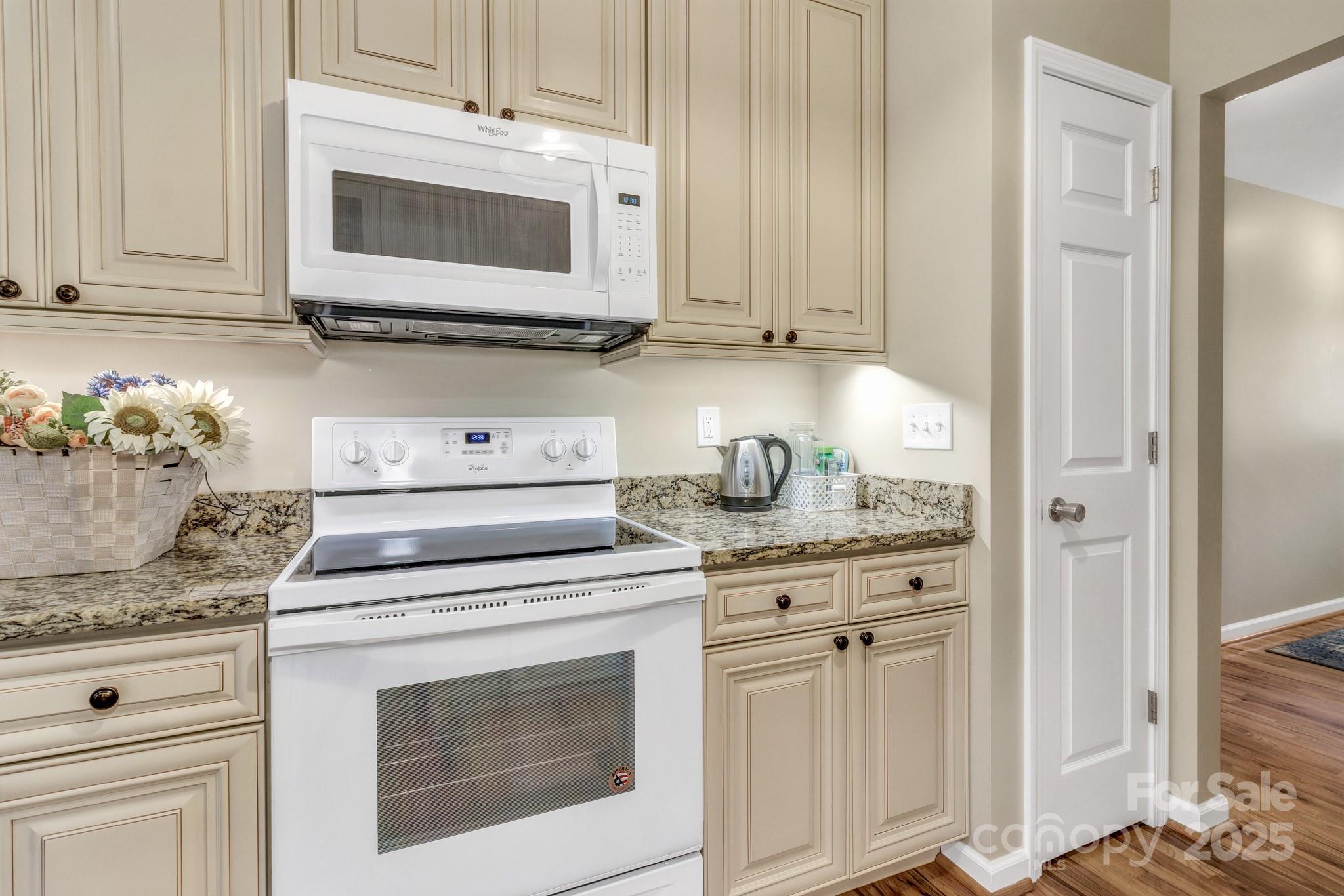 210 Allen Paul Road Hendersonville, NC 28791 - Photo 23 of 48 a kitchen with granite countertop white cabinets and white appliances
