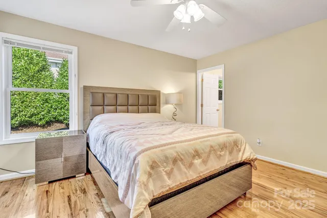 a large bed sitting in a bedroom next to a window