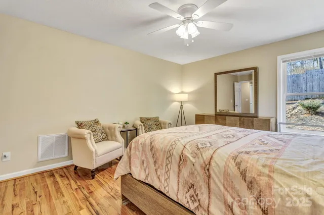 a spacious bedroom with a bed and a chandelier