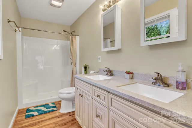 a bathroom with a sink a toilet and shower curtain