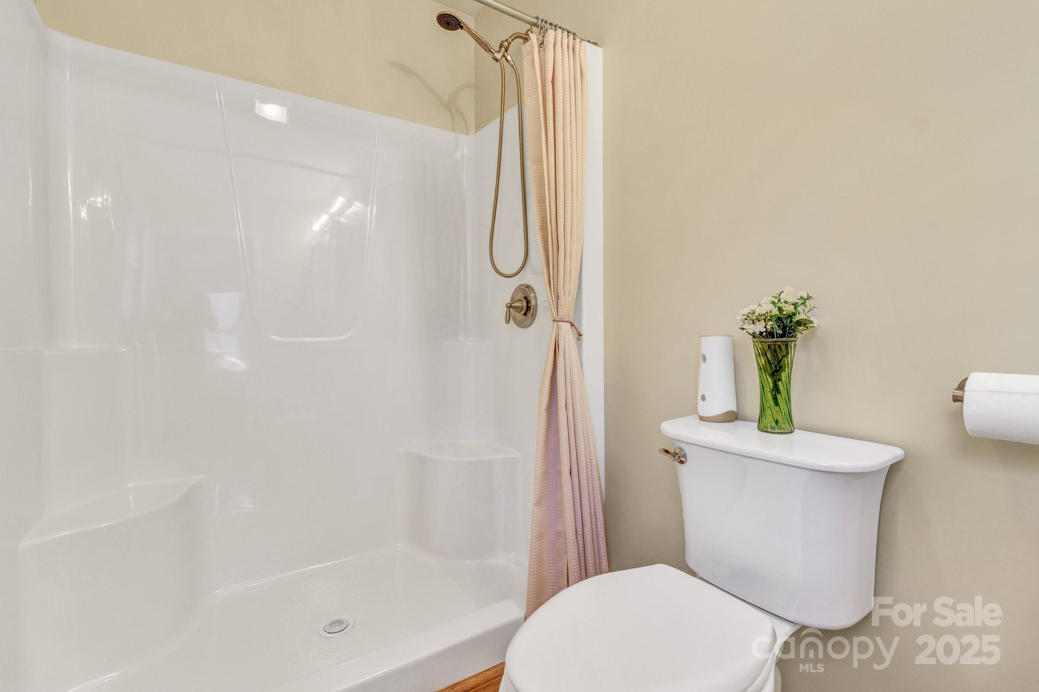 210 Allen Paul Road Hendersonville, NC 28791 - Photo 32 of 48 a white toilet sitting next to a bath tub