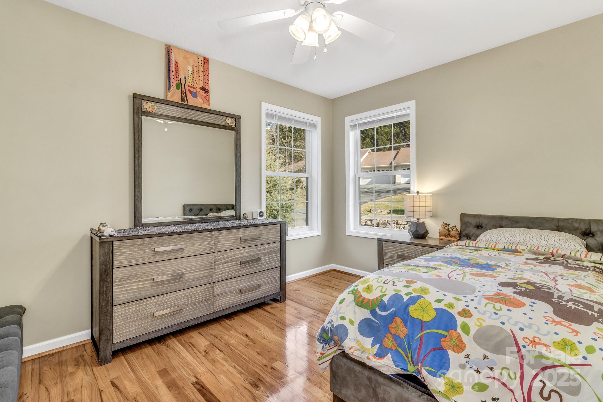 210 Allen Paul Road Hendersonville, NC 28791 - Photo 36 of 48 a bedroom with a bed and a dresser in it