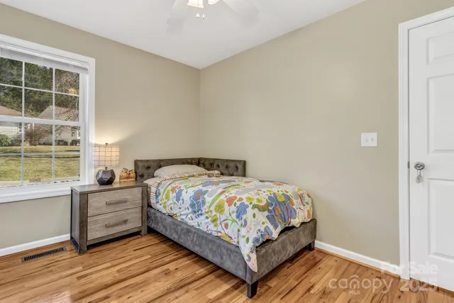 a bedroom with a bed and windows