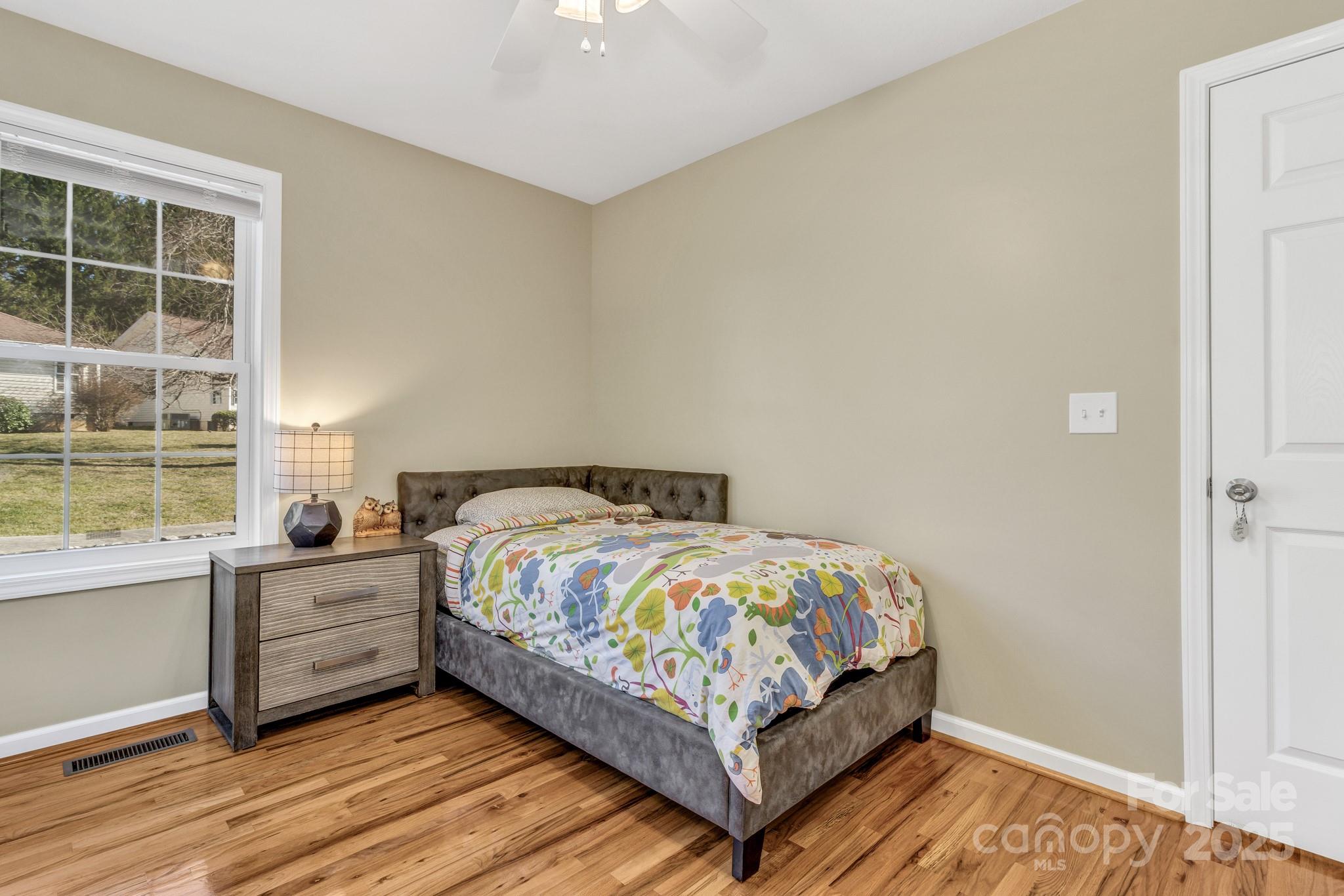 210 Allen Paul Road Hendersonville, NC 28791 - Photo 38 of 48 a bedroom with a bed and windows