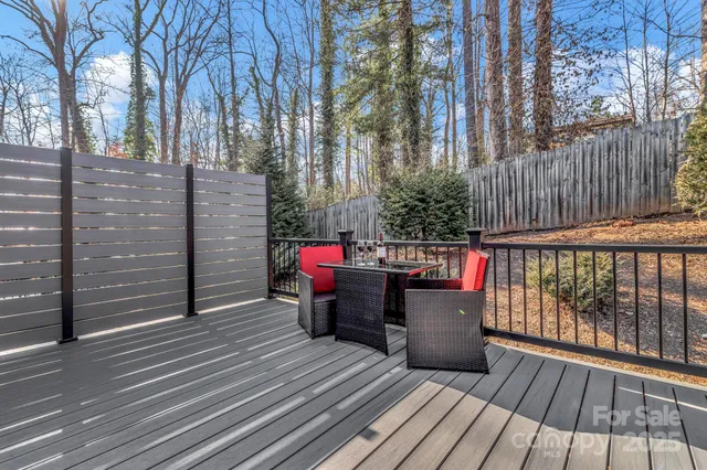 a view of a chairs on the deck in front of house