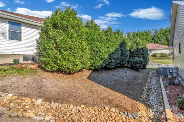 a view of a garden with lawn chairs