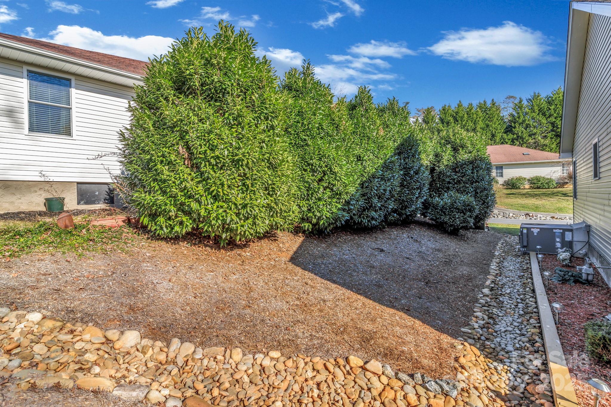 210 Allen Paul Road Hendersonville, NC 28791 - Photo 48 of 48 a view of a garden with lawn chairs