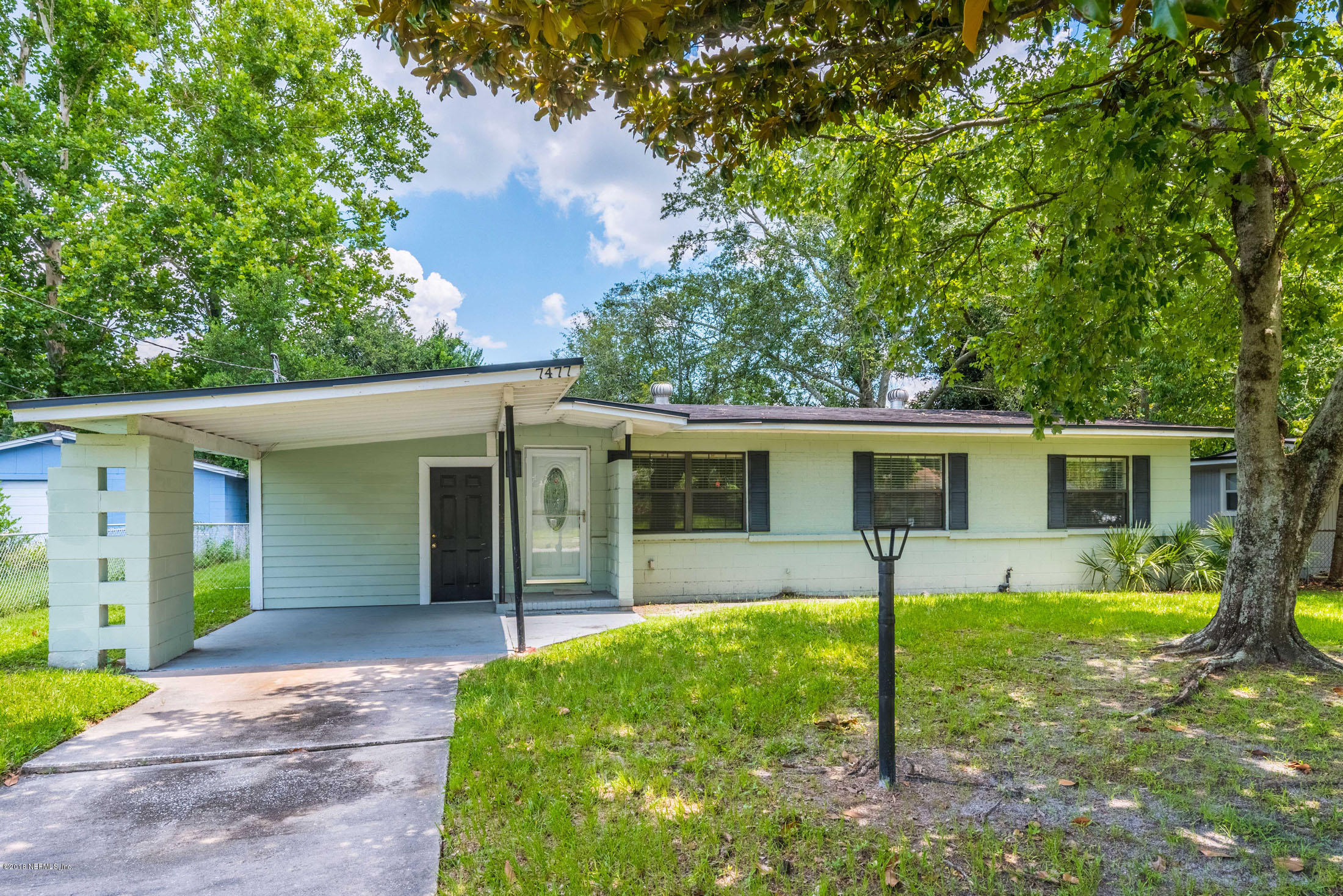 7477 Strato Road Jacksonville, FL 32210 - Photo 1 of 25 front view of a house with a yard