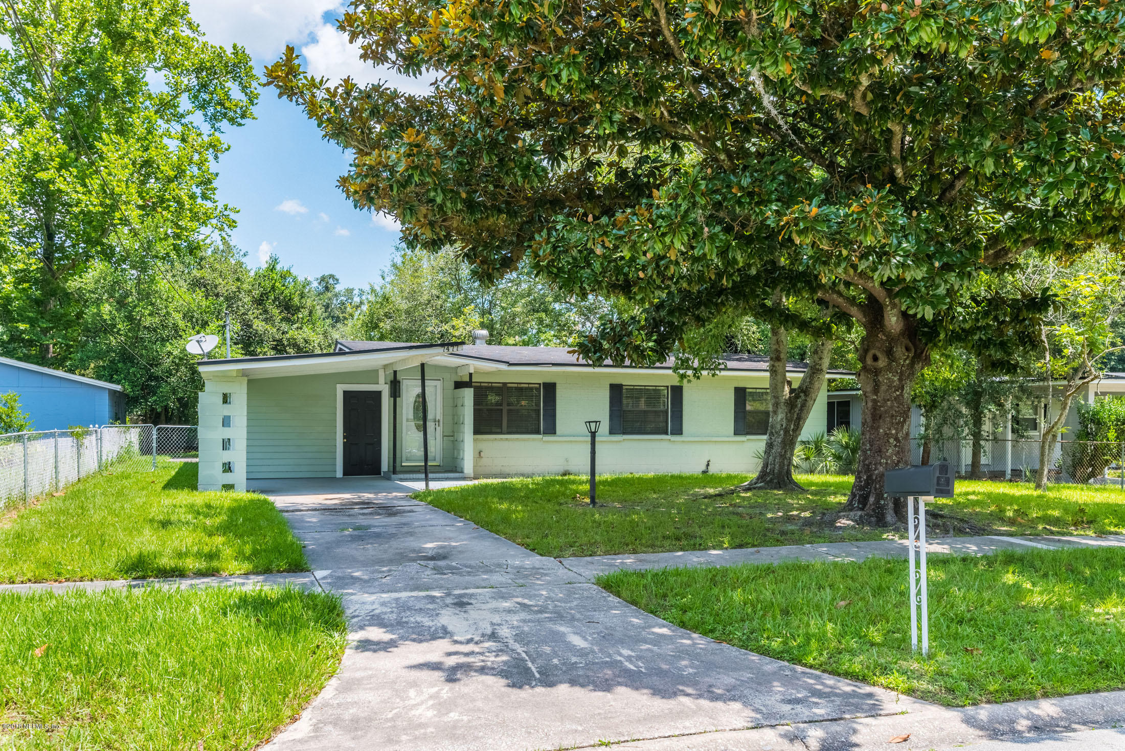 7477 Strato Road Jacksonville, FL 32210 - Photo 2 of 25 a front view of house with a garden and trees