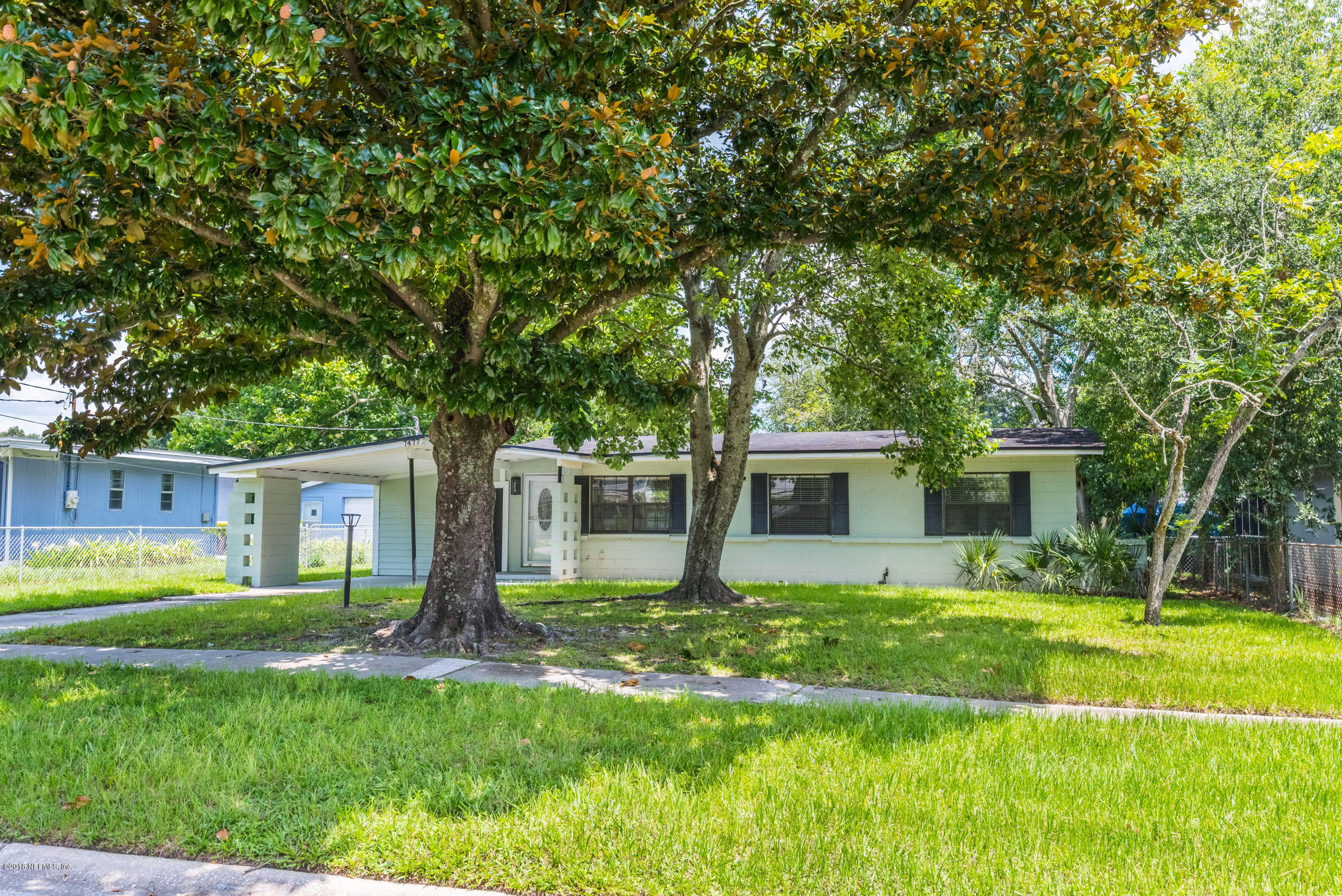7477 Strato Road Jacksonville, FL 32210 - Photo 3 of 25 a front view of house with yard and green space