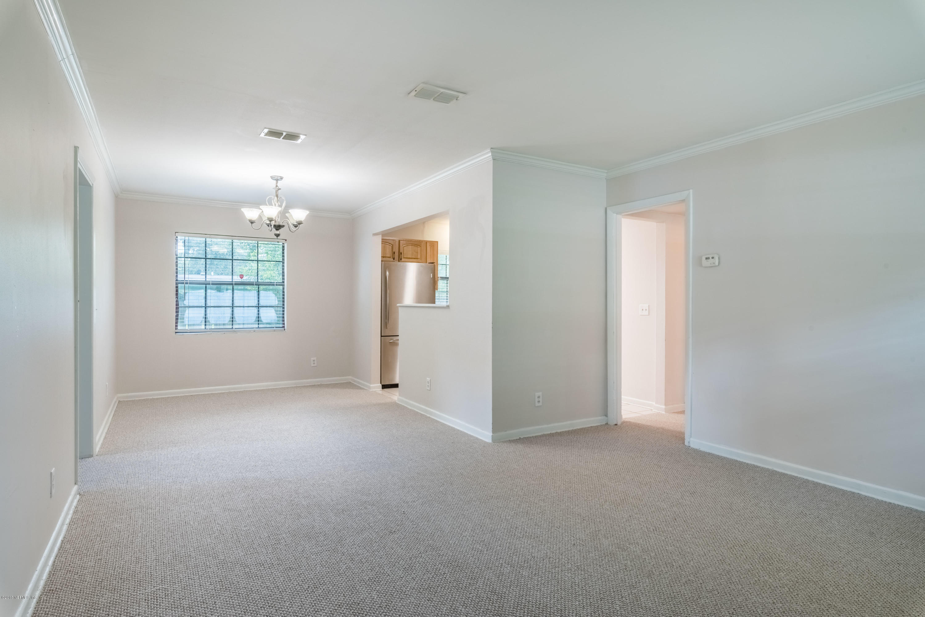7477 Strato Road Jacksonville, FL 32210 - Photo 6 of 25 an empty room with windows