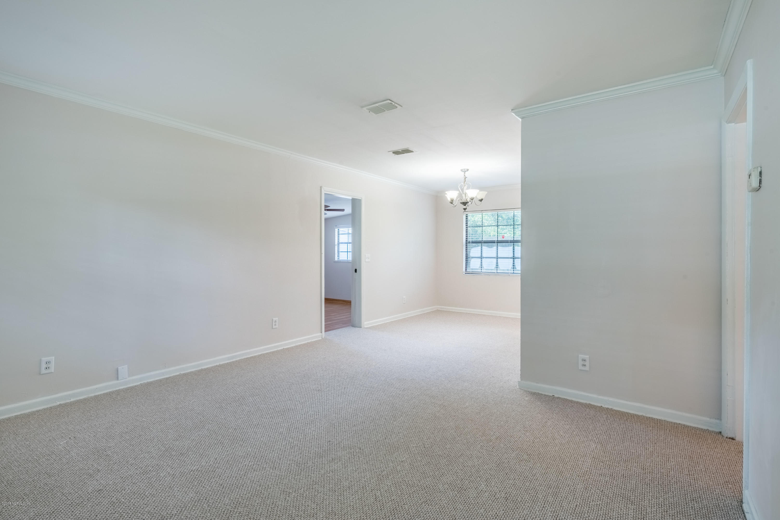 7477 Strato Road Jacksonville, FL 32210 - Photo 7 of 25 an empty room with windows and closet