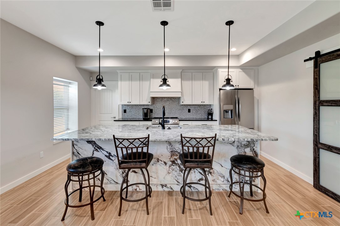 52 Coastal Oaks Loop Port O'Connor, TX 77982 - Photo 5 of 23 a view of a dining room with furniture and wooden floor