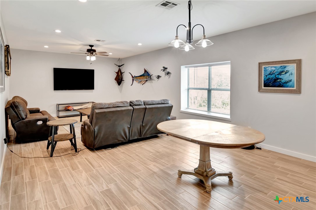 52 Coastal Oaks Loop Port O'Connor, TX 77982 - Photo 8 of 23 a living room with furniture and a flat screen tv