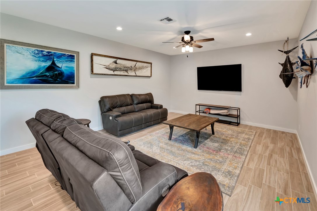 52 Coastal Oaks Loop Port O'Connor, TX 77982 - Photo 9 of 23 a living room with furniture and a flat screen tv