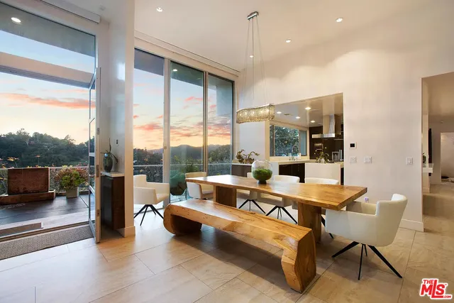 a living room with patio furniture and a floor to ceiling window
