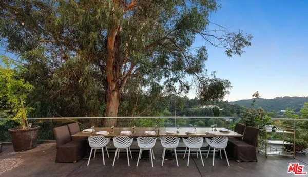 an outdoor seating area with furniture and wooden floor