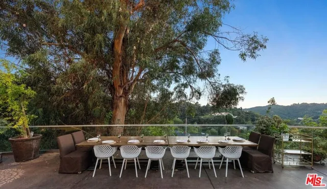 an outdoor seating area with furniture and wooden floor