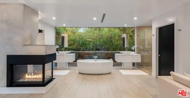 a living room with furniture a lamp and a fireplace