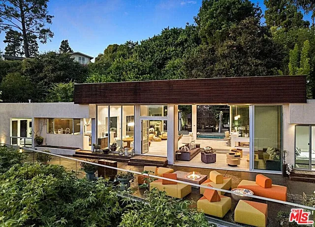 an outdoor sitting area with couch and lounge chair