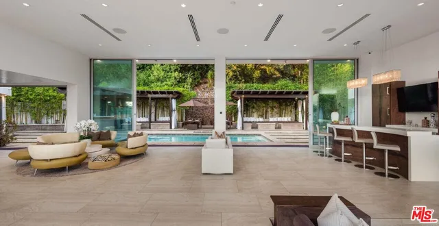 a living room with furniture and large windows