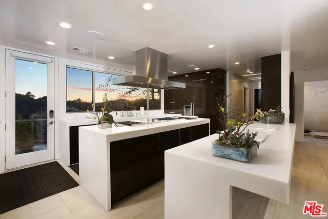 a kitchen with a sink and white cabinets