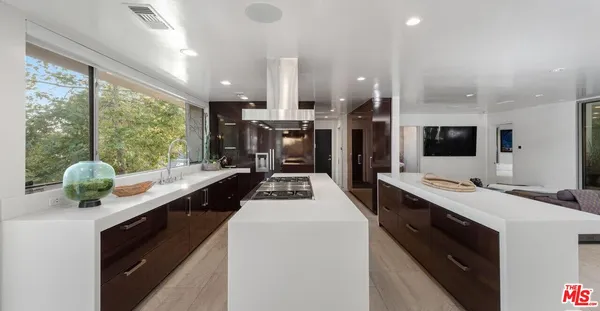 a kitchen with stainless steel appliances a sink stove and refrigerator