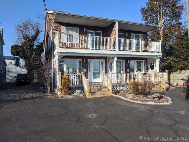 a front view of a house with garden and porch