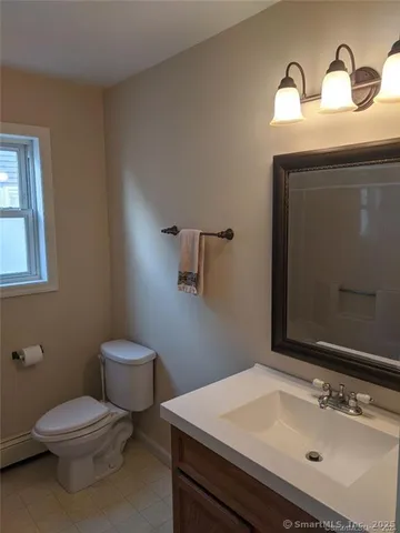 a bathroom with a sink toilet and mirror